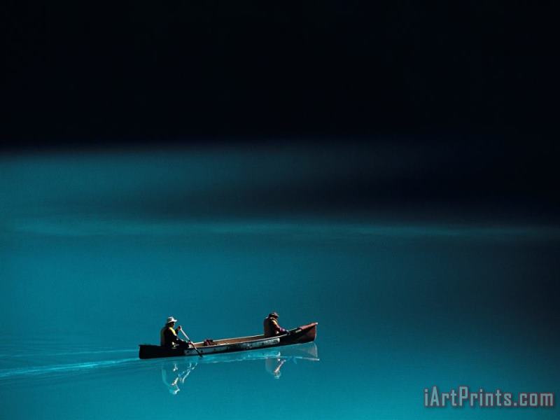 Raymond Gehman A Canoe Plies The Mirror Smooth Surface of Lake Louise Art Print