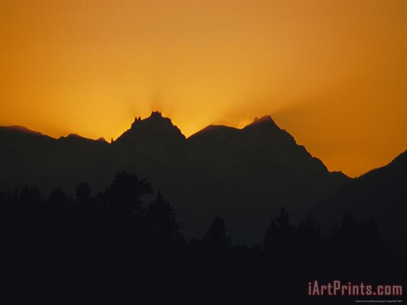 Mountain Peaks Appear in Silhouette at Twilight painting - Raymond Gehman Mountain Peaks Appear in Silhouette at Twilight Art Print