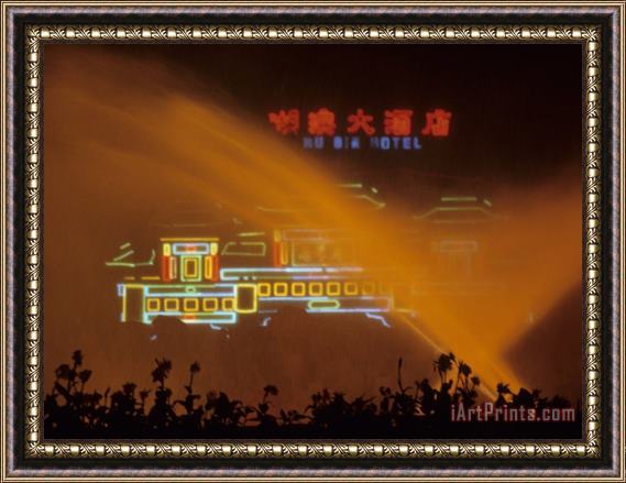 Raymond Gehman A Hotels Neon Signs Shining Through a Water Fountain at Night Framed Painting