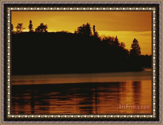 Raymond Gehman A Twilight View of a Lake And a Silhouette of a Tree Covered Mountain Framed Print