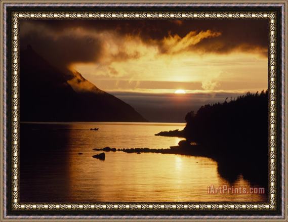 Raymond Gehman Cloud Filtered Sunset Silhouettes a Boat on The Sheltered Waters of Bonne Bay Framed Print