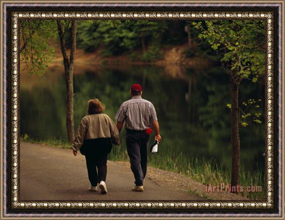 Raymond Gehman Couple Walking by The Water Along a Park Road Framed Print
