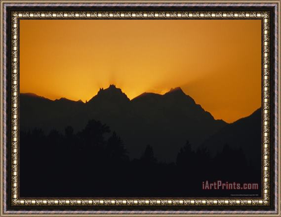 Raymond Gehman Mountain Peaks Appear in Silhouette at Twilight Framed Painting