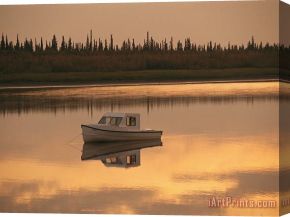 Raymond Gehman An Anchored Boat Floats on The Mackenzie River at Sunset Stretched Canvas Print / Canvas Art