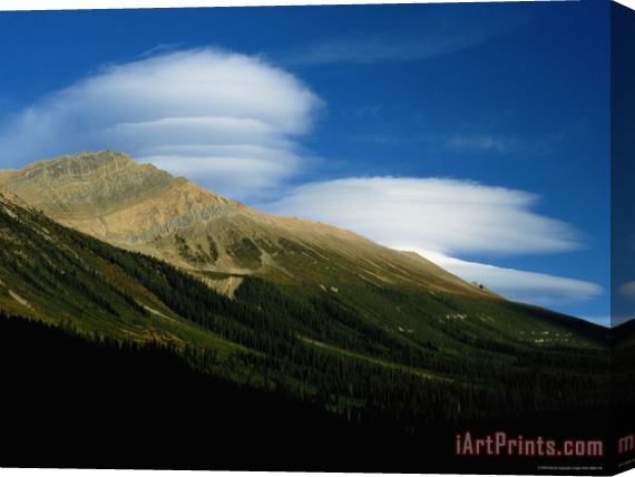 Raymond Gehman High Clouds Over a Mountainous Landscape Stretched Canvas Print / Canvas Art