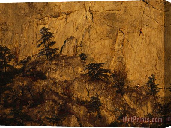 Raymond Gehman Rock Outcrop with Sheer Cliffs And Silhouetted Evergreen Trees Stretched Canvas Print / Canvas Art