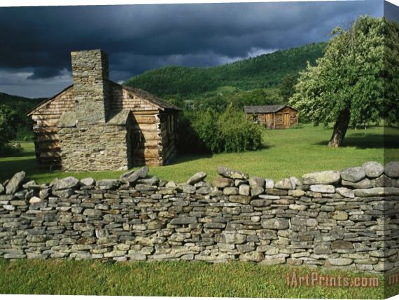 Raymond Gehman Storm Clouds Form Above Log Buildings on The Site of French Azilum Stretched Canvas Print / Canvas Art
