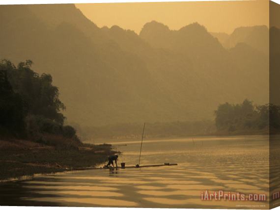 Raymond Gehman Woman Fishes Along The Mingjiang River at Sunset Stretched Canvas Print / Canvas Art