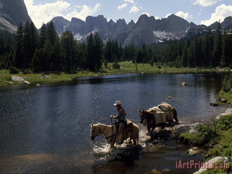 Raymond Gehman A Guide Leads a Pack String Across The North Popo Agie River Below Cirque of The Towers Peaks Art Print