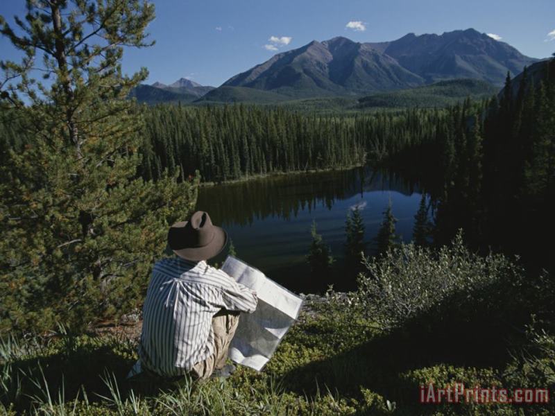 Raymond Gehman A Man with a Cowboy Hat Reads a Map And Gazes Across a River Art Painting