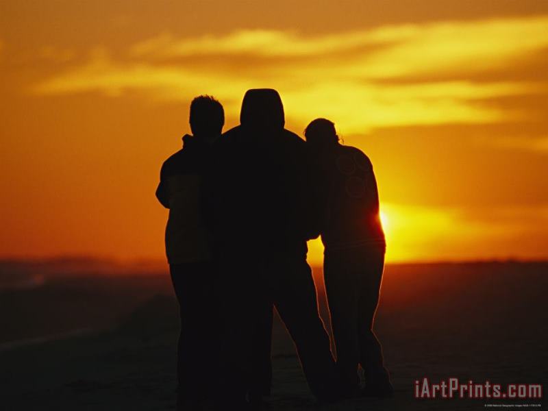 A Silhouetted Family Watches a Dramatic Sunset painting - Raymond Gehman A Silhouetted Family Watches a Dramatic Sunset Art Print