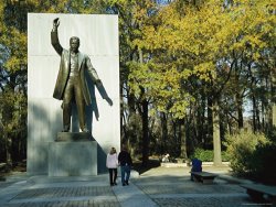 Raymond Gehman Bronze Statue of Theodore Roosevelt with Yellow Oak Leaves And Nearby Couple