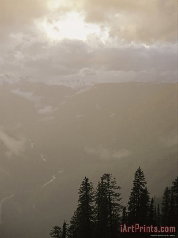 Clouds And Fog Obscure The Valley Along Logan Pass painting - Raymond Gehman Clouds And Fog Obscure The Valley Along Logan Pass Art Print