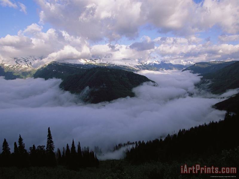 Raymond Gehman Clouds Shroud The Valley And Fill The Sky Along Logan Pass Art Print