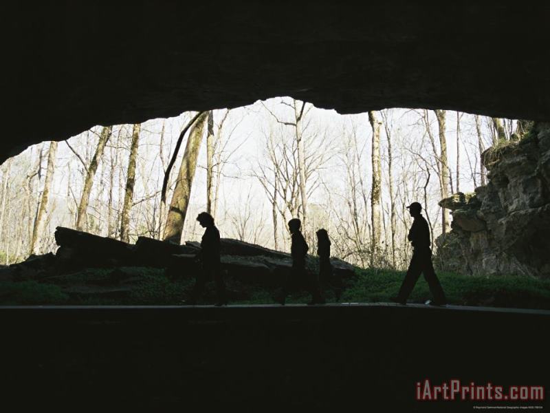 Family of Hikers Silhouetted in Front of a Cave Entrance painting - Raymond Gehman Family of Hikers Silhouetted in Front of a Cave Entrance Art Print