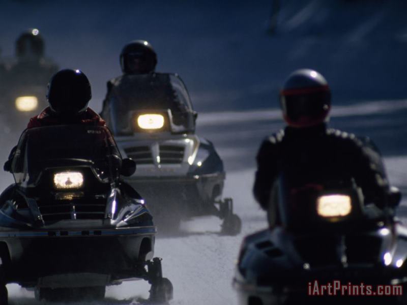 Raymond Gehman Snowmobilers Ride Down a Snowy Road in Yellowstone Park Art Print