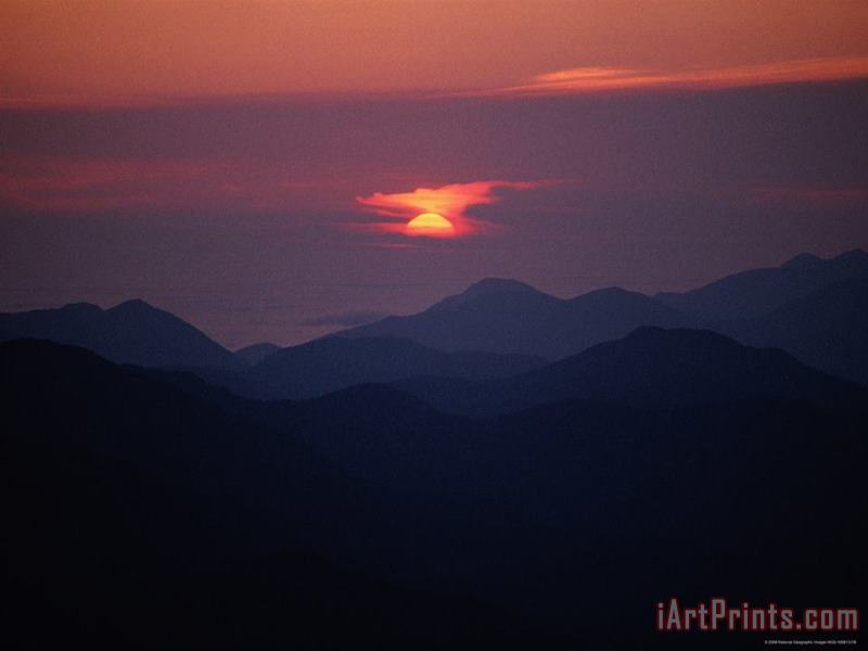 Raymond Gehman Sunrise Over a Silhouetted Range of Mountains Art Painting