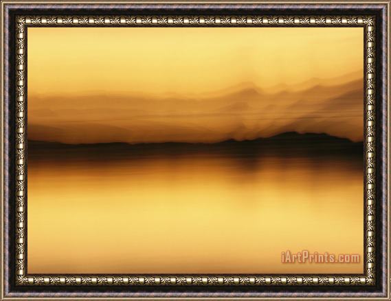 Raymond Gehman A Blurred View of Spruce Trees Along The Mackenzie River at Sunset Framed Print