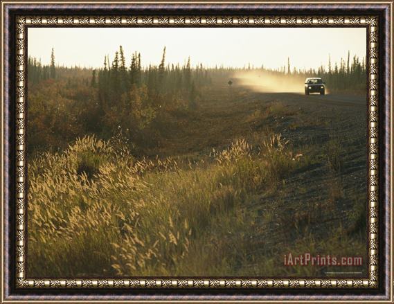 Raymond Gehman A Lone Vehicle Drives Down The Open Road of The Mackenize Highway Framed Print