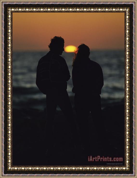 Raymond Gehman A Silhouetted Couple Watching The Sunset at Blind Pass Framed Print