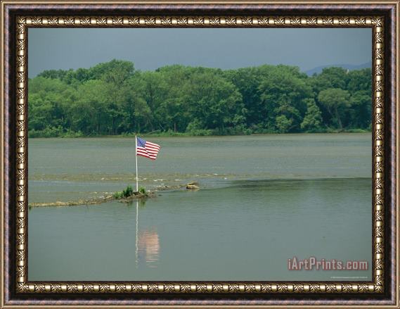 Raymond Gehman An American Flag Marks a Rock Outcrop Near a Ferry Crossing Framed Print