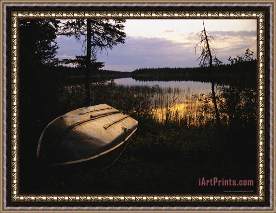 Raymond Gehman An Upturned Rowboat on The Shore of Iskwasum Lake at Sunset Framed Print