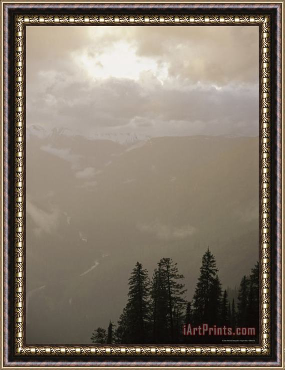 Raymond Gehman Clouds And Fog Obscure The Valley Along Logan Pass Framed Print