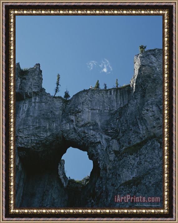 Raymond Gehman Erosion Carves a Window Into Limestone Rock in Nahanni National Park Framed Painting