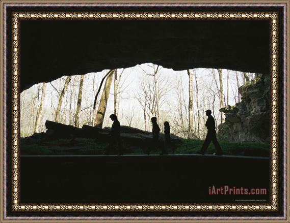 Raymond Gehman Family of Hikers Silhouetted in Front of a Cave Entrance Framed Print