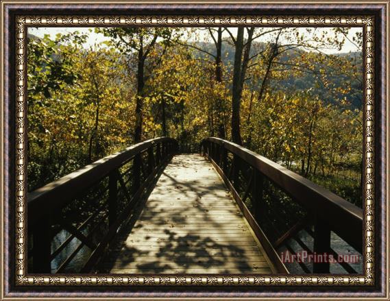 Raymond Gehman Footbridge Over Waterway in Autumn Hued Woods in a Mountain Valley Framed Print