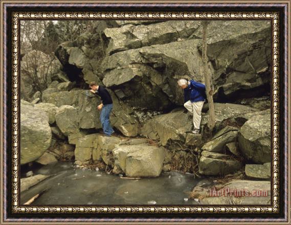 Raymond Gehman Hikers Climb a Rock Formation on Great Falls Billy Goat Trail Framed Print