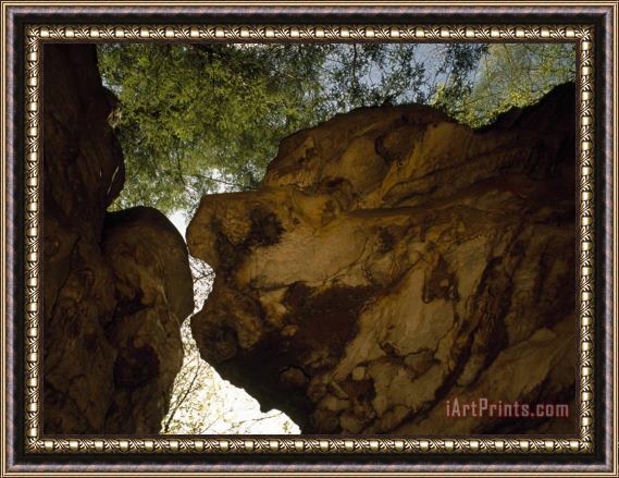 Raymond Gehman Looking Up at Large Over Hanging Boulders in a Wooded Setting Framed Painting