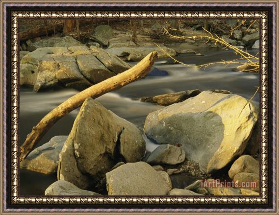 Raymond Gehman Rock Creek Rushes Past Large Boulders And Driftwood at Sunset Framed Print
