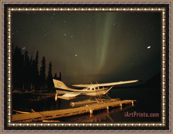 Raymond Gehman The Aurora Borealis Glows Brightly Over a Seaplane Docked on Cli Lake Framed Print