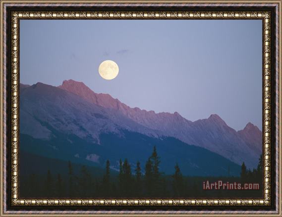 Raymond Gehman The Full Moon Over Mountains Lit by Low Sunlight Framed Print