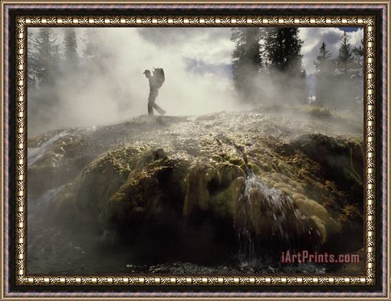 Raymond Gehman Venting Steam Veils a Hiker Skirting a Hot Spring in The Bechler Backcountry Framed Painting