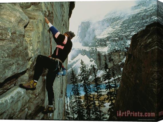 Raymond Gehman A Climber Ascends The Quartzite Cliffs at The End of Lake Louise Stretched Canvas Print / Canvas Art