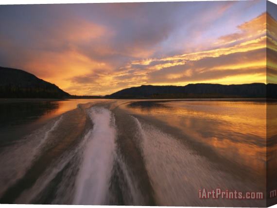 Raymond Gehman A Jet Boat Leaves a Wake in The Mackenzie River at Sunset Stretched Canvas Painting / Canvas Art