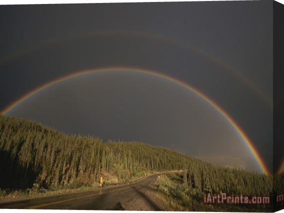 Raymond Gehman A Rainbow Arches Over The Alaska Highway in British Columbia Canada Stretched Canvas Print / Canvas Art