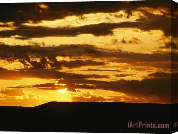 Raymond Gehman Clouds Are Colored Shades of Orange by The Low Sun Over 70 Mile Butte Stretched Canvas Print / Canvas Art