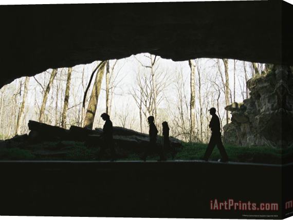 Raymond Gehman Family of Hikers Silhouetted in Front of a Cave Entrance Stretched Canvas Print / Canvas Art