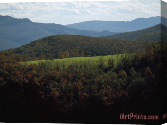 Raymond Gehman Field in Foothills Surrounded by Mountain Ridges Stretched Canvas Print / Canvas Art
