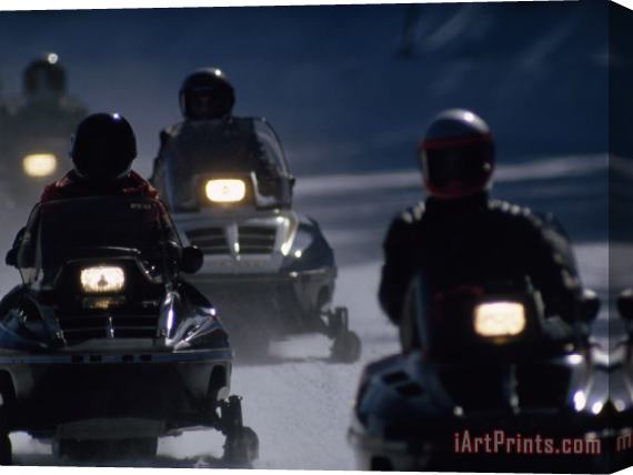 Raymond Gehman Snowmobilers Ride Down a Snowy Road in Yellowstone Park Stretched Canvas Painting / Canvas Art