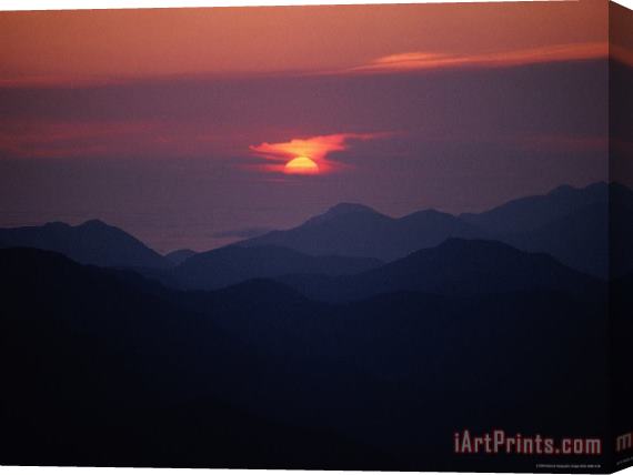 Raymond Gehman Sunrise Over a Silhouetted Range of Mountains Stretched Canvas Painting / Canvas Art