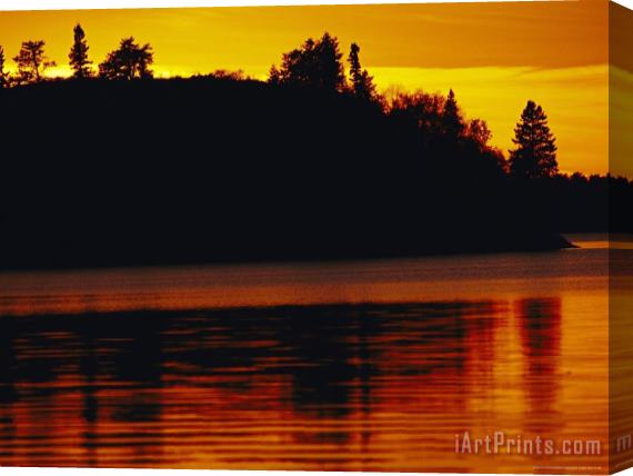 Raymond Gehman The Setting Sun Casts an Orange Glow Over Manitoba's White Lake Stretched Canvas Painting / Canvas Art