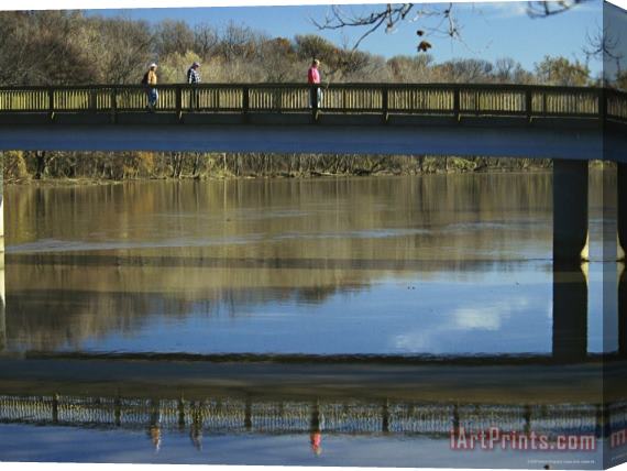 Raymond Gehman Three Men Cross a Footbridge Between Rosslyn And The Potomac River Stretched Canvas Print / Canvas Art
