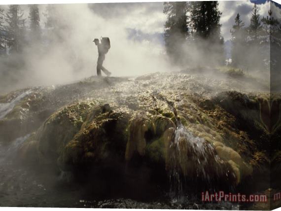 Raymond Gehman Venting Steam Veils a Hiker Skirting a Hot Spring in The Bechler Backcountry Stretched Canvas Print / Canvas Art